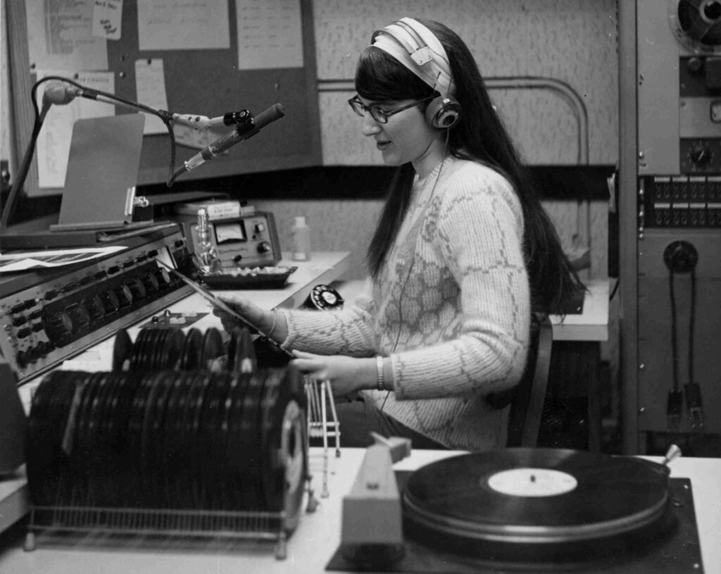 Donna Halper as a young announcer at radio station WNEU in October 1968, cueing a record — the first female DJ in the station history